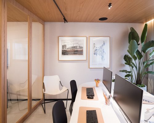 Cozy modern office space with wooden furniture and warm lighting